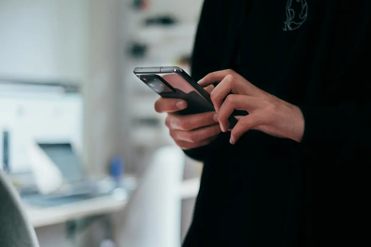 A person holding a smartphone in both hands